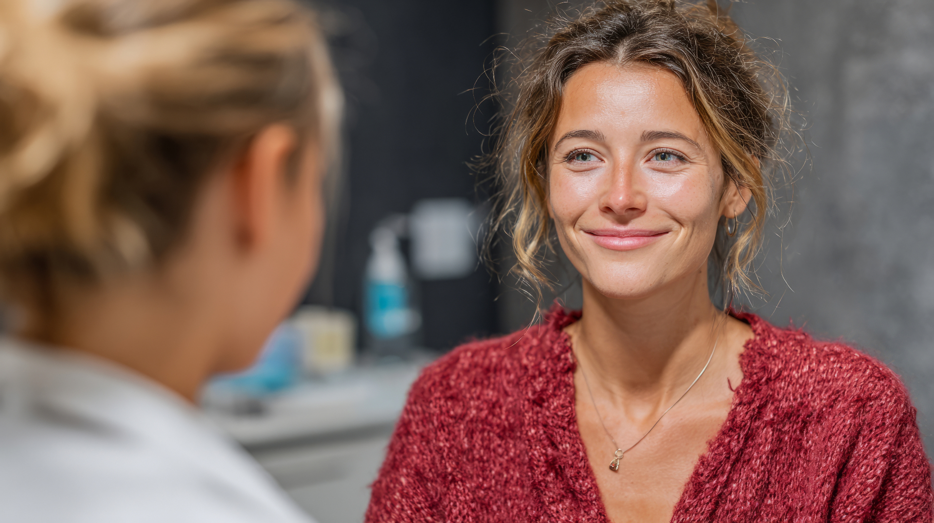 Smiling woman in conversation with her doctor